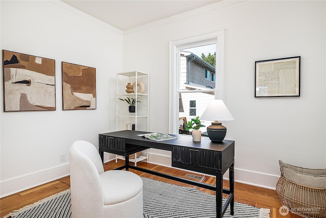 home office with baseboards, wood finished floors, and crown molding