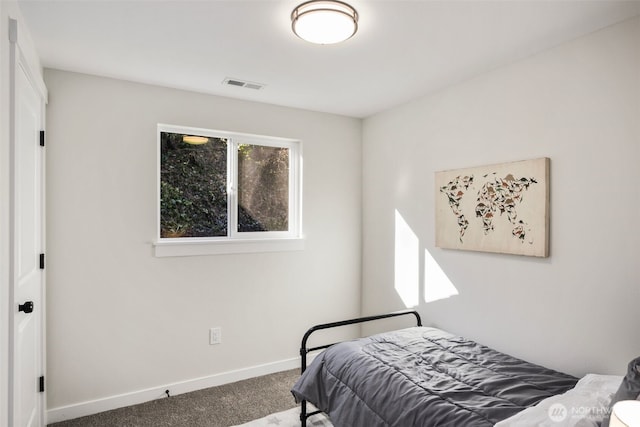 carpeted bedroom featuring visible vents and baseboards