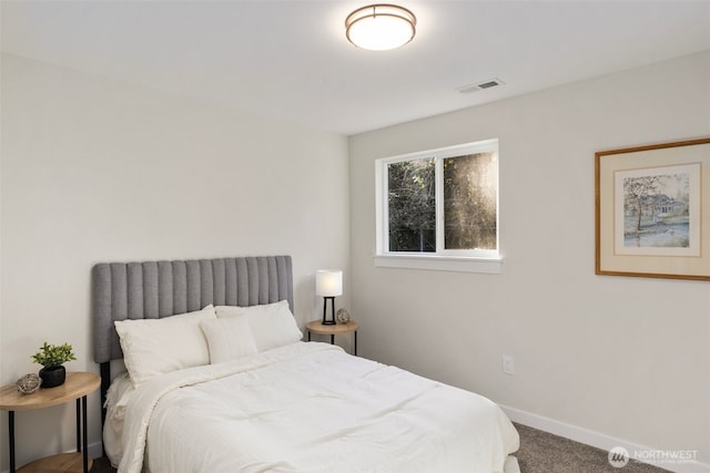 carpeted bedroom featuring visible vents and baseboards