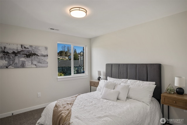 bedroom featuring baseboards, carpet floors, and visible vents