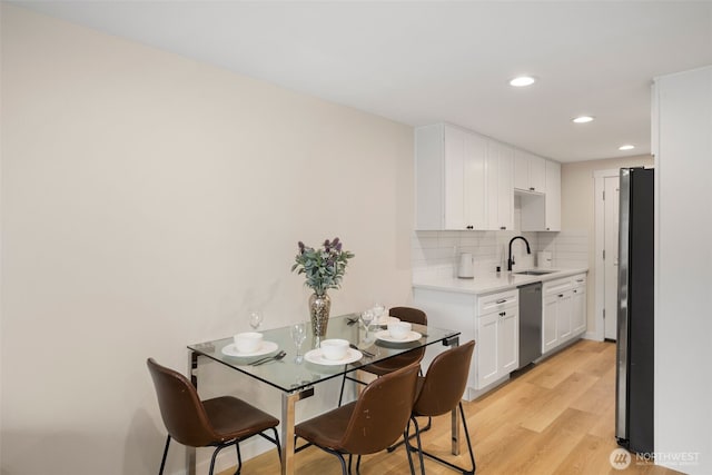 dining room with recessed lighting and light wood-type flooring