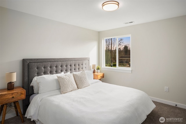 bedroom with visible vents, dark carpet, and baseboards