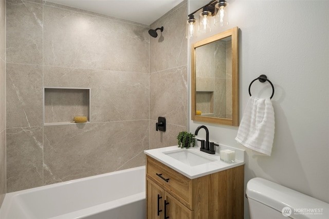 bathroom featuring vanity, shower / tub combination, and toilet