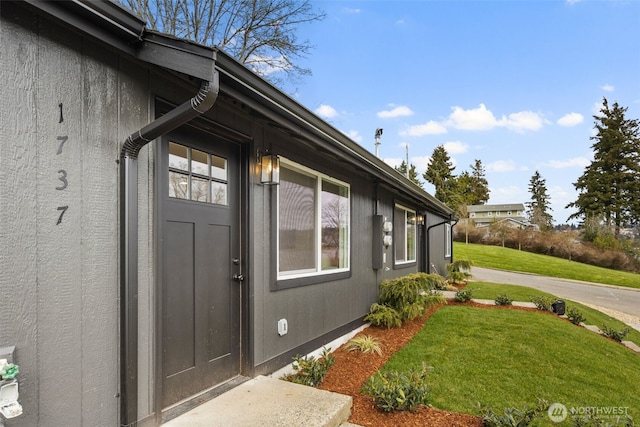 entrance to property with a lawn