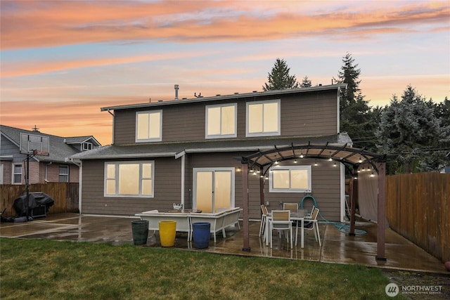 rear view of property with a yard, a patio area, a pergola, and a fenced backyard