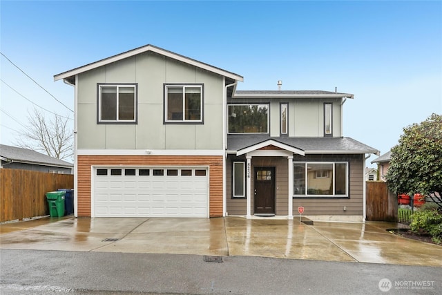 view of front of house with driveway, an attached garage, and fence