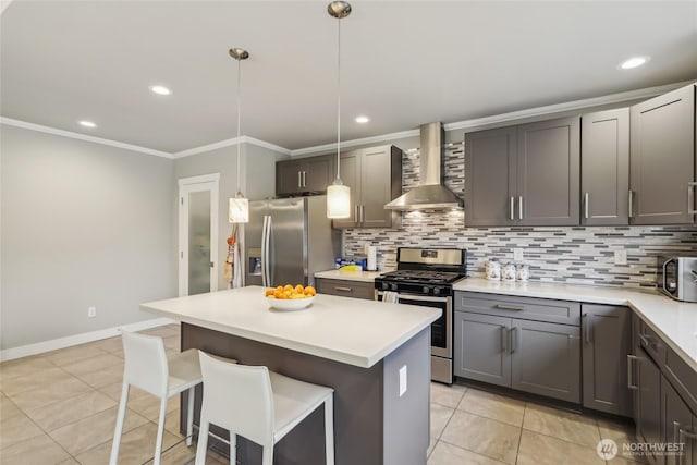 kitchen featuring tasteful backsplash, crown molding, a kitchen breakfast bar, stainless steel appliances, and wall chimney exhaust hood