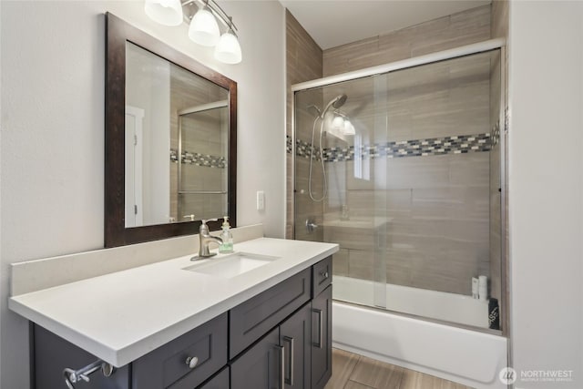 full bath featuring combined bath / shower with glass door and vanity