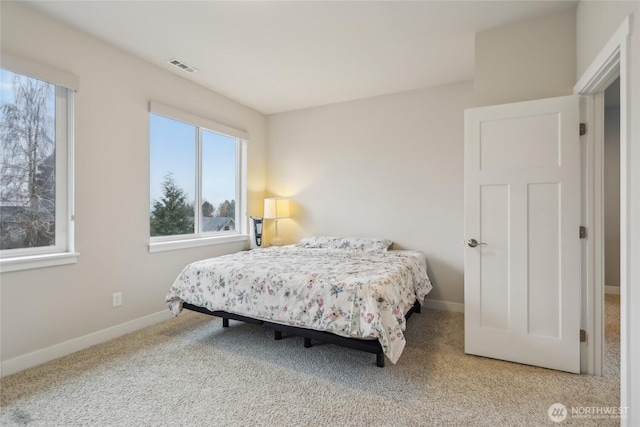 bedroom featuring visible vents, baseboards, and carpet floors