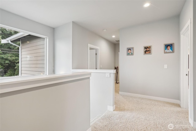 hallway featuring visible vents, recessed lighting, carpet, and baseboards