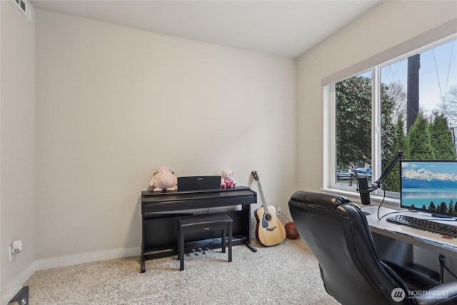 carpeted office featuring a healthy amount of sunlight, visible vents, and baseboards