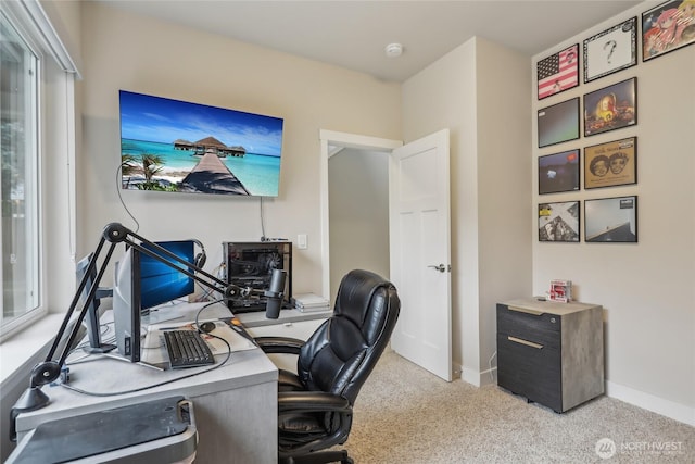 carpeted office featuring baseboards