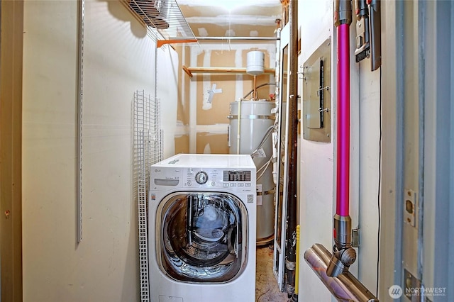 clothes washing area featuring water heater, laundry area, washer / dryer, and electric panel