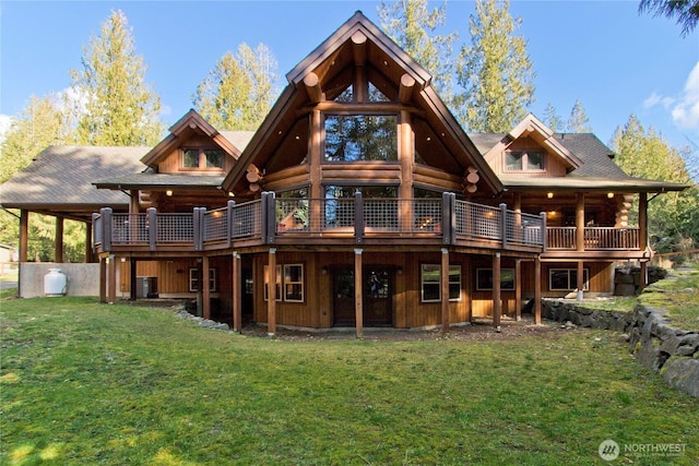 back of house featuring a yard, a wooden deck, and log exterior