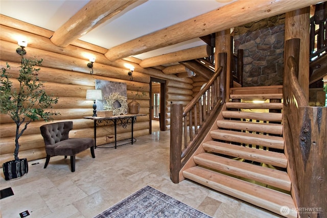 stairs with rustic walls, beamed ceiling, visible vents, and stone finish flooring