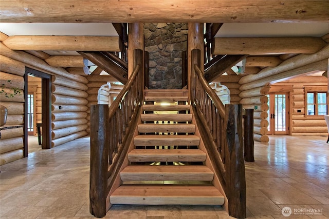 stairway featuring beam ceiling and stone tile floors