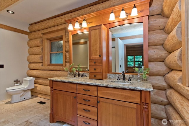 bathroom featuring double vanity, log walls, a bidet, and a sink