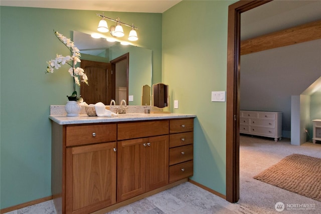 bathroom with vanity and baseboards