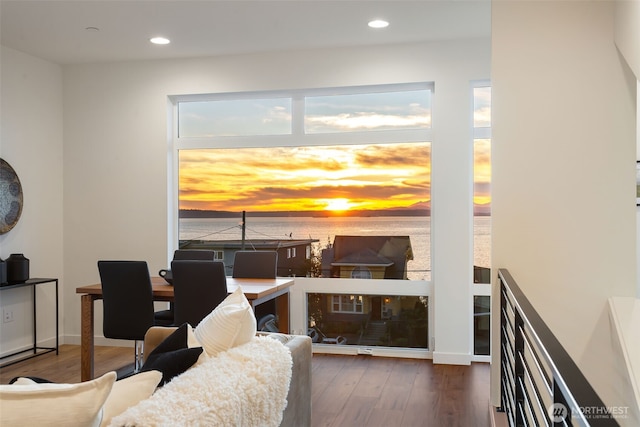 living area with recessed lighting, baseboards, and wood finished floors