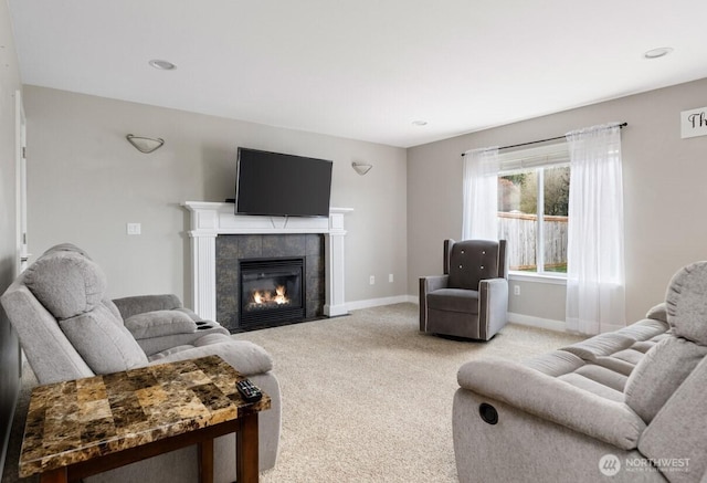 living room featuring a tiled fireplace, recessed lighting, light colored carpet, and baseboards