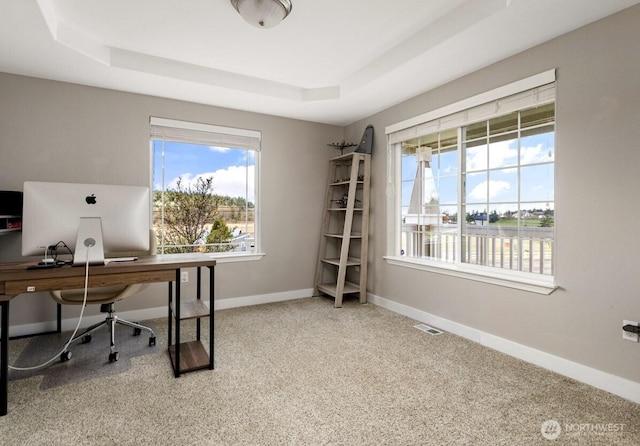 home office featuring a raised ceiling, carpet, baseboards, and visible vents