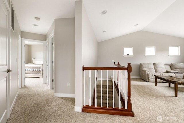 hallway featuring an upstairs landing, carpet flooring, and plenty of natural light