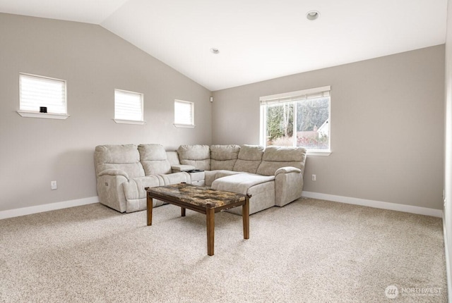 living room with baseboards, light carpet, and lofted ceiling