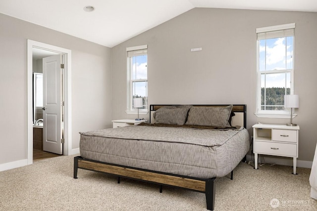 carpeted bedroom with baseboards, multiple windows, and vaulted ceiling