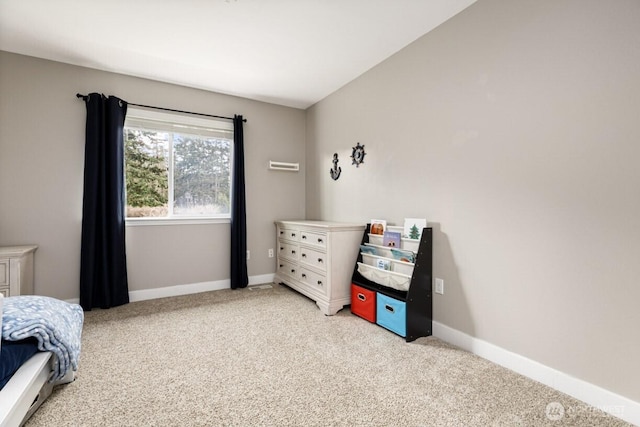 bedroom featuring baseboards and light carpet