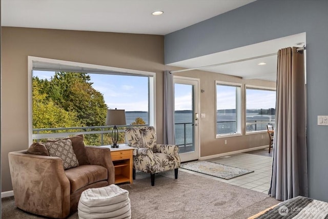 interior space featuring lofted ceiling, recessed lighting, carpet, tile patterned flooring, and baseboards