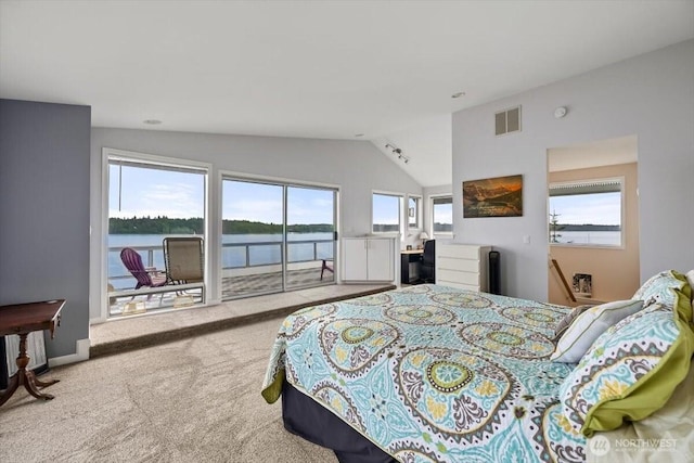 carpeted bedroom featuring visible vents, multiple windows, access to exterior, and vaulted ceiling