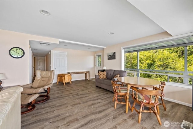 dining room with visible vents, baseboards, and wood finished floors