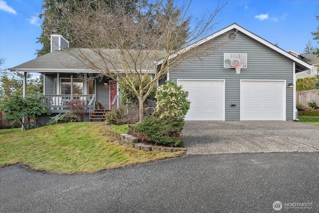 single story home featuring covered porch, a chimney, a front lawn, a garage, and aphalt driveway