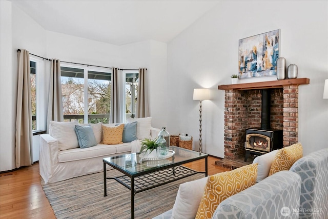 living room featuring wood finished floors and a wood stove