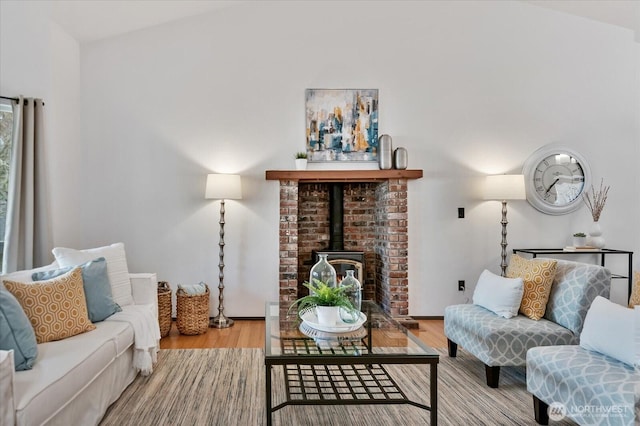 living room with wood finished floors and a wood stove