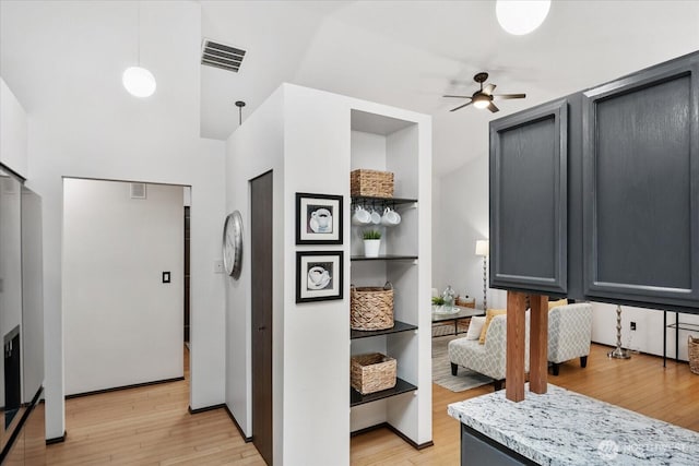 kitchen with gray cabinetry, visible vents, light wood finished floors, and ceiling fan