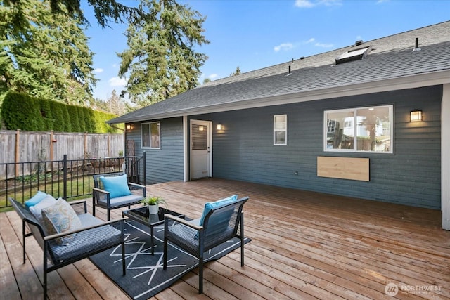 wooden deck featuring outdoor lounge area and fence