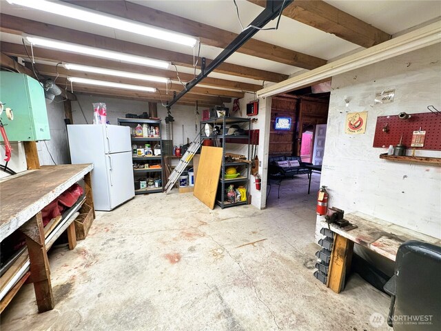 2254 Riffle Dr, Leavenworth, WA 98826 - unfinished below grade area featuring a workshop area and freestanding refrigerator
