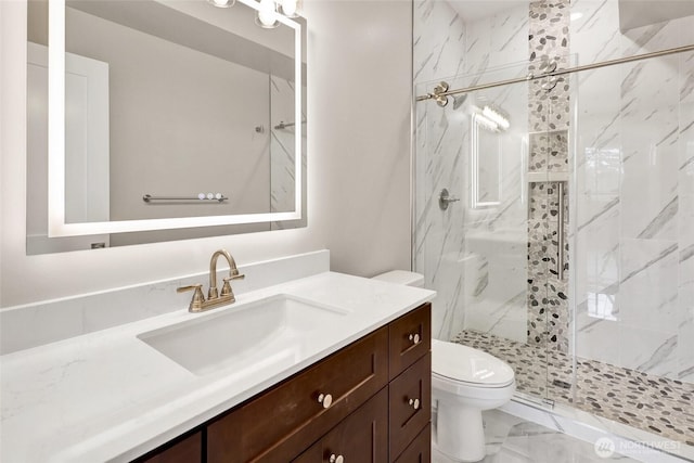 full bathroom with marble finish floor, vanity, toilet, and a shower stall