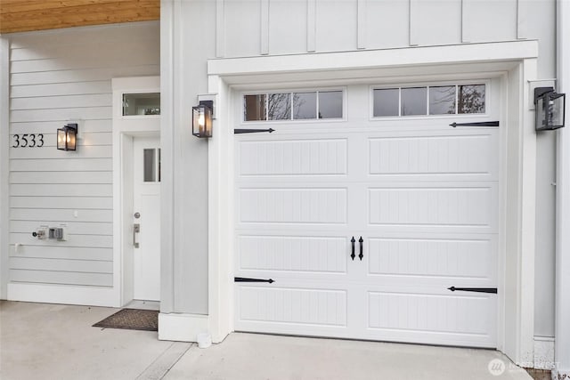 doorway to property featuring board and batten siding and a garage