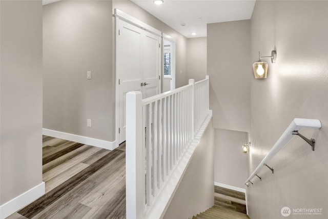 staircase with recessed lighting, baseboards, and wood finished floors