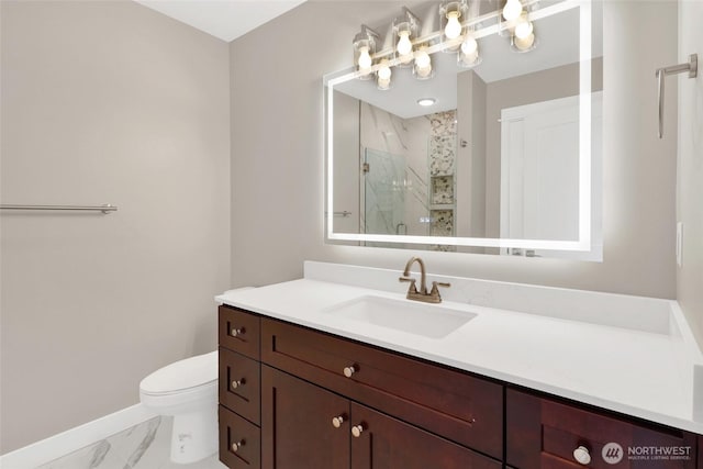 bathroom with vanity, baseboards, a stall shower, toilet, and marble finish floor