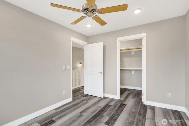 unfurnished bedroom featuring a closet, ceiling fan, baseboards, and wood finished floors