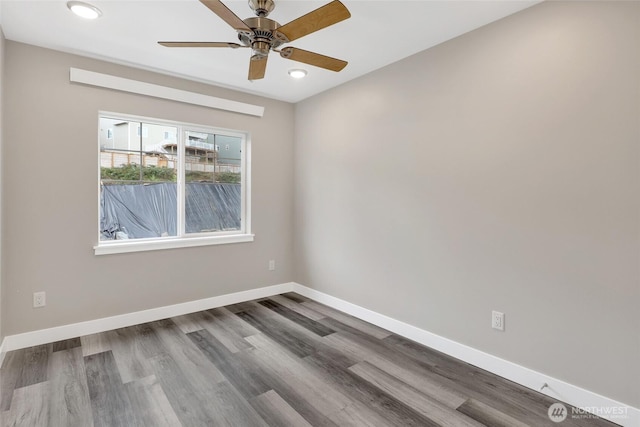 spare room featuring recessed lighting, a ceiling fan, baseboards, and wood finished floors