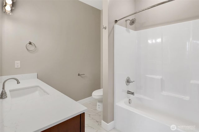 full bath with vanity, baseboards, toilet, marble finish floor, and shower / bathtub combination