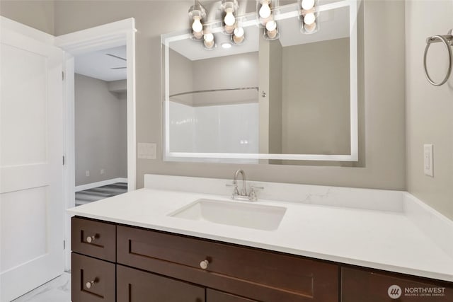 full bathroom featuring vanity, a shower, and marble finish floor