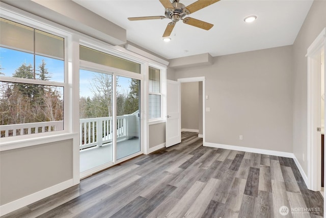 unfurnished bedroom with wood finished floors, baseboards, recessed lighting, ceiling fan, and access to exterior