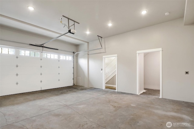 garage featuring recessed lighting and a garage door opener