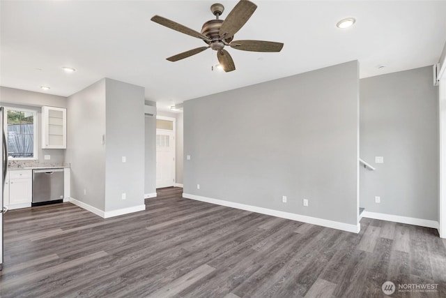 unfurnished living room featuring dark wood-type flooring, a ceiling fan, and baseboards