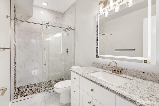 full bath featuring a marble finish shower, toilet, marble finish floor, and vanity